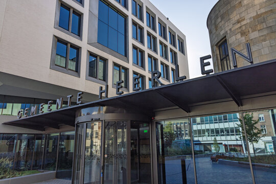 Heerlen, Netherlands - October 04, 2026: Modern glass revolving door entrance and lettering sign of Heerlen City Hall Gemeentehuis building.