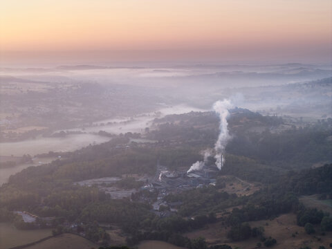 Beautiful drone landscape image over Stanton Moor in Summer Heather sunrise