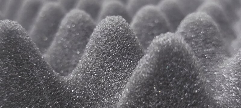 Materials that absorb sound waves instead of blocking them.