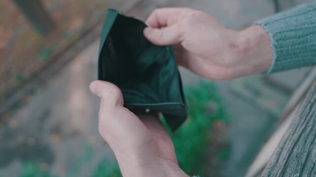 Man Hands Holding Open Empty Black Leather Wallet Without Money or Cards: Top-Down View, Close-Up Shot | Shallow Depth of Field, Outdoor Bench | Poverty Financial Crisis Bankruptcy Concept