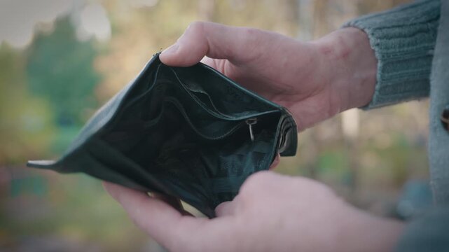 Man Hands Holding Open Empty Black Leather Wallet Without Money or Cards: Side View, Close-Up Shot | Shallow Depth of Field, Blurred Autumn Park | Poverty Financial Crisis Bankruptcy Concept