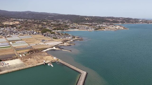 Aerial drone footage flying over Isahaya reclaimed farmland and Ariake Sea coastline