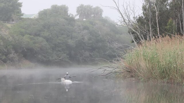 kayaker on Klein River on a foggy misty morning, Stanford, South Africa