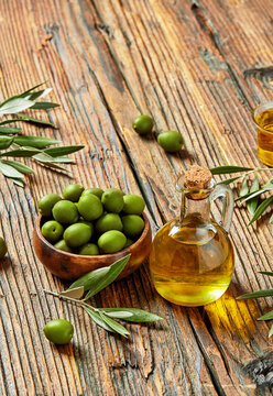 Fresh green olives and olive oil in rustic setting, Mediterranean food concept