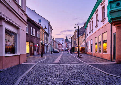 Cobbled main street with shops at dusk in Slany Czech Republic