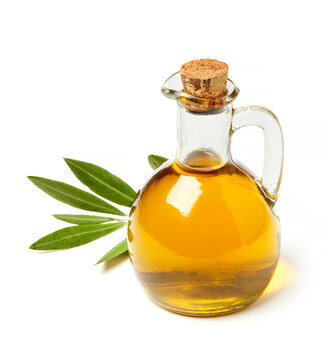 Olive oil bottle with fresh olive leaves isolated on white