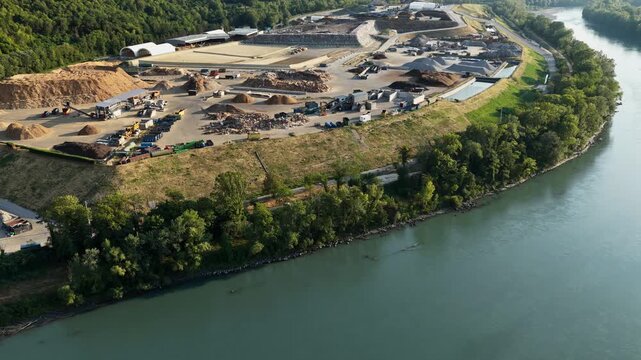 Aerial panorama of a large waste recovery and material processing site on the bank of a river near Grenoble