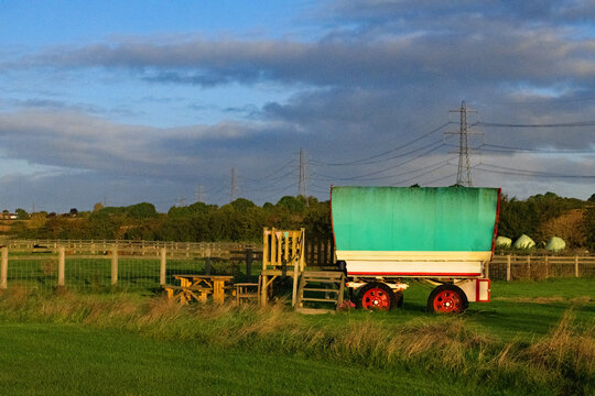 Autumnal dawn glow on gypsy caravan.