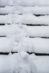 Fototapeta premium Snow-Covered Steps with Footprints in Fresh Winter Snow