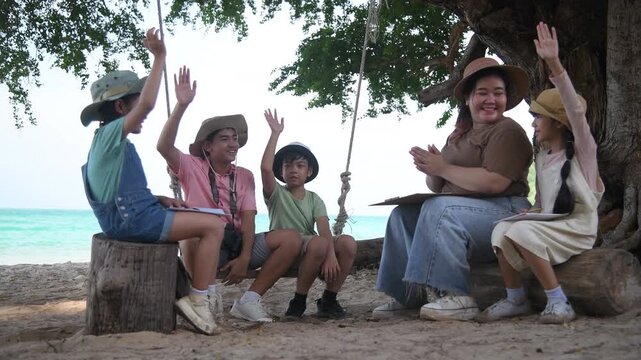 Group of teacher and school children on ecotourist trip and binoculars learning show beach take care of environment.