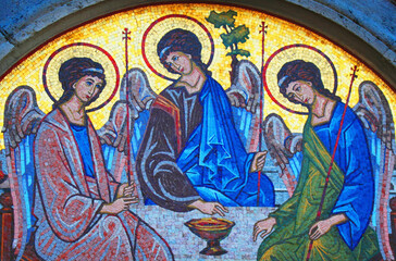 Fototapeta premium Colorful Christian mosaic depicting the Holy Trinity as three angels seated around a table, symbolizing divine unity, faith, love, harmony and spiritual communion.