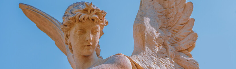 Fototapeta premium Guardian angel with wings and a star against a clear blue sky, symbolizing divine protection, hope, guidance and connection with heaven.