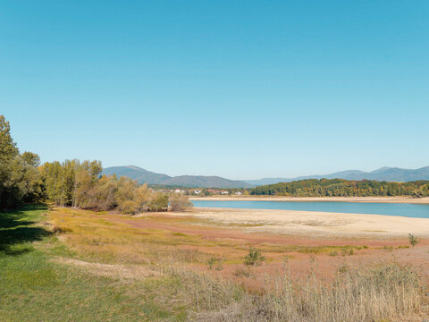 The Michelbach dam in Alsace is surrounded by a nature reserve in a peaceful setting. The banks and lakebed are exposed during periods of low water and accessible from the lake path