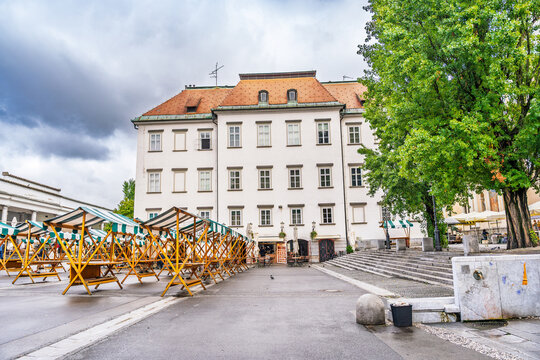 Ljubljana Central Market with empty wooden stalls and historic architecture on a cloudy day