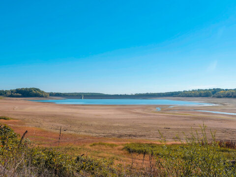 Michelbach artificial dam - Lake water reservoir in the Aspach-Michelbach and Aspach-Le-Bas nature reserve in Alsace during the low water period, bordered by sandbanks, peat bogs and reedbeds