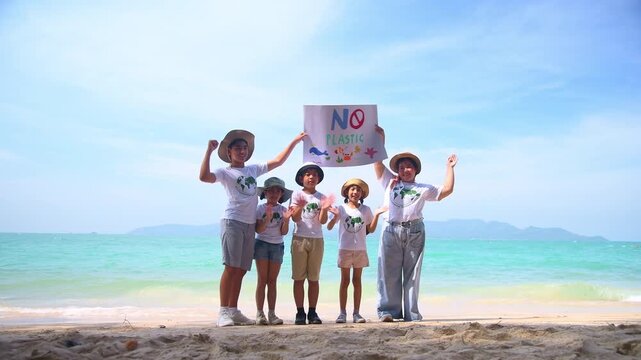 Group of teacher and school children on ecotourist trip  learning show beach take care of environment.