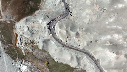 Fototapeta premium winding mountain road on pamir plateau aerial view