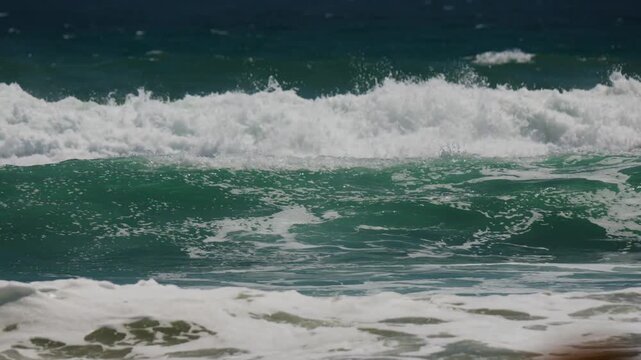 Surf waves breaking on a beach in California