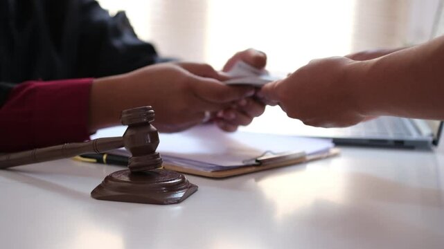 Lawyer is refusing a bribe from his client who is offering him a wad of cash. Full of integrity. Fight against corruption, bribery
