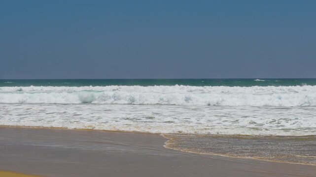 wide shot of large surf breaking on the beach in Orange county CA