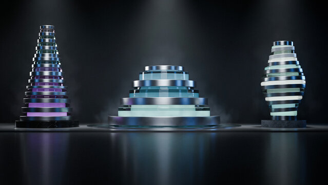 Three tiered conical metallic sculptures with glowing light rings arranged on a dark reflective floor with atmospheric fog and overhead spotlighting