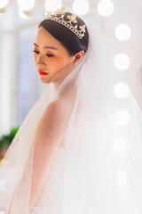 Elegant East Asian Bride Portrait with Pearl Tiara and Beaded Veil, Romantic Wedding Shot © jeson