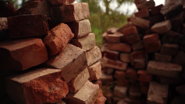 Stacked red clay bricks in outdoor yard