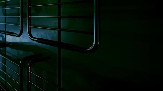 In a dark setting, metallic rods cast intriguing shadows across the wall, creating a surreal atmosphere that invites curiosity and imagination. The quiet space feels almost alive with mystery.