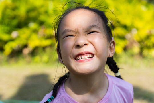 A little girl making a face