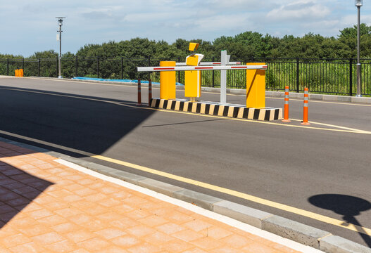 Yellow parking barrier system on an asphalt street
