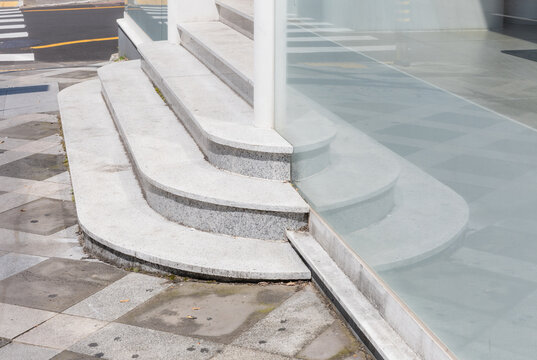 Curved Granite Stairs Leading to Modern Glass Building Entrance