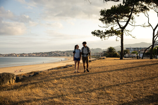 Couple chatting along the coastal Camino