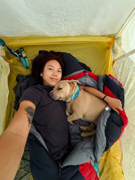 ugc selfie camping with dog snuggling in tent