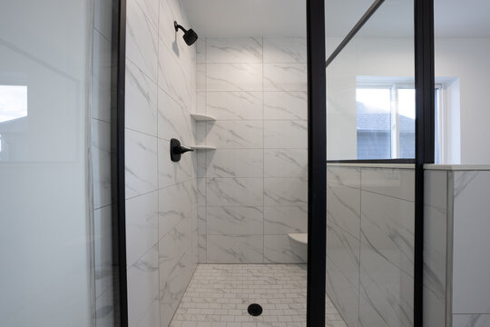 Bathroom shower has been updated with new ceramic tile and fixtures