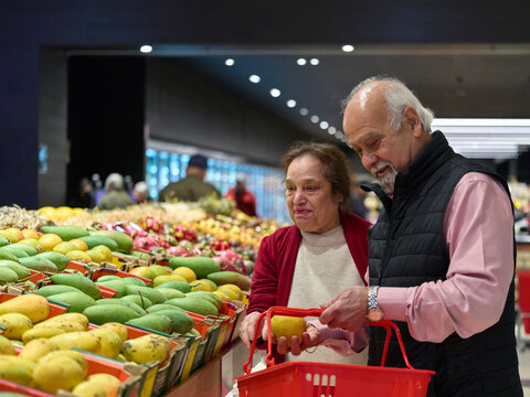 Elderly Couple Shopping for Fruits in a Grocery Store