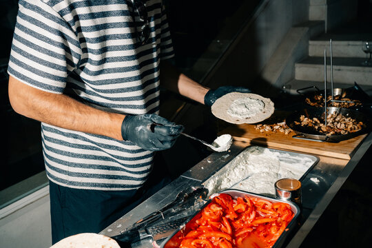 Chef Prepares Food at a Street Food Stall in the Evening