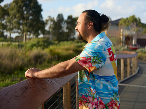 Man Stands on Bridge and Looks at Nature in the Background