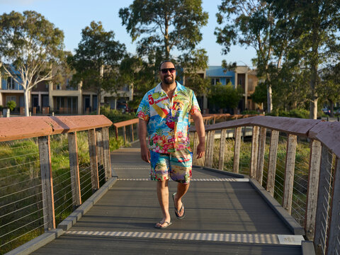Man Walking on a Bridge During the Evening in a Sunny Location