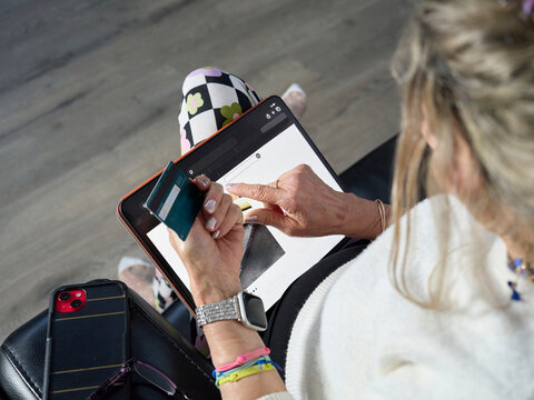 Person Using an iPad and Credit Card While Shopping Online
