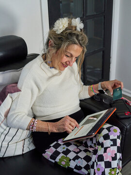 Senior Lady Enjoying Some Online Shopping At Home on Counch