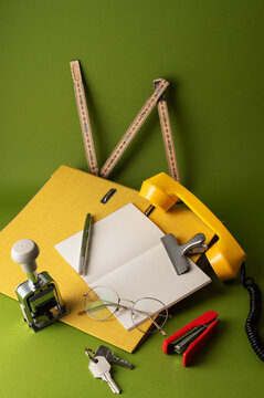 Flat lay of vintage stationery and notebook on green
