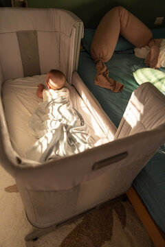 Infant Doing Tummy Time in Crib at Home
