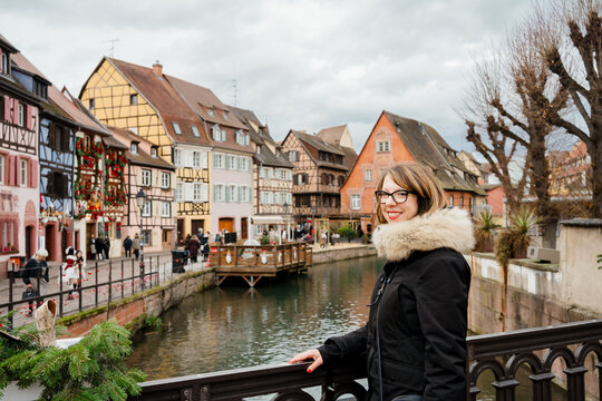 A woman visiting Colmar's old town for Christmas
