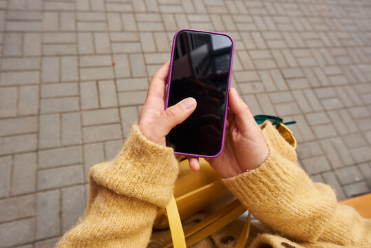 POV of woman holding smartphone with empty screen