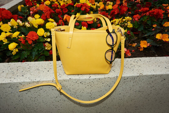 Yellow bag against colorful flowers. Flash
