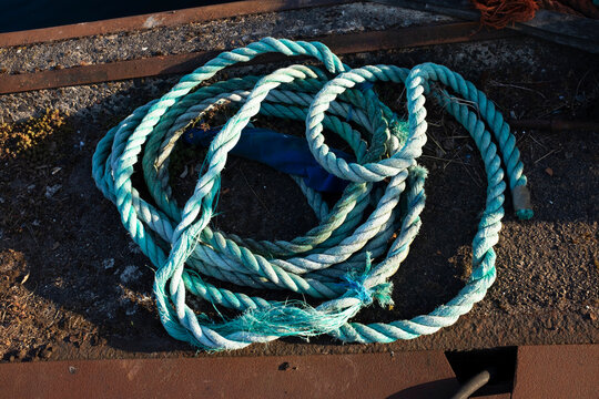 Light baby blue rope and background with rust and sunlight