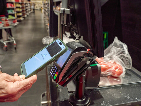 Paying With a Smartphone at a Checkout in a Grocery Store