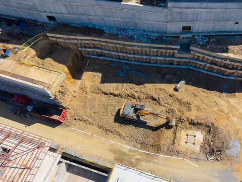 Aerial View Of Excavator Working At Construction Foundation Pit