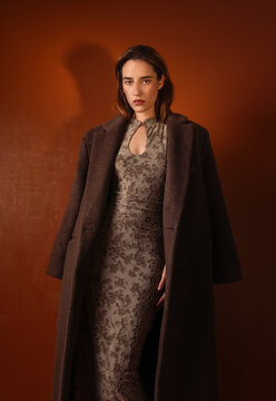 Elegant Woman in Brown Coat and Textured Dress