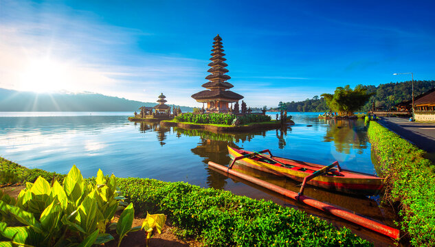 Pura Ulun Danu Bratan, Hindu temple with boat on Bratan lake landscape at sunrise in Bali, Indonesia.